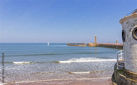 Whitby beach with roundhouse and pier. Stock Photo | Adobe Stock