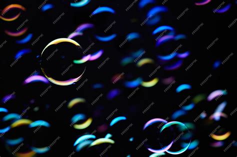 Premium Photo | A black background with colorful bubbles floating in ...