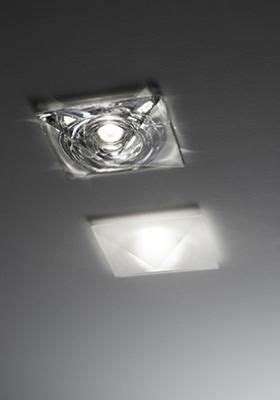 Two Square Lights Are On The Ceiling And One Is Dimmerged From The Light