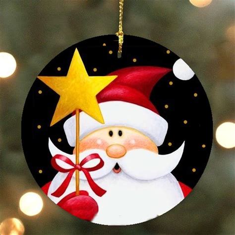 A Christmas Ornament With A Santa Clause Holding A Star