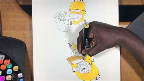 someone is drawing simpsons on paper with crayons