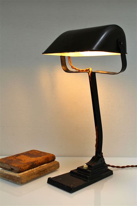 A Desk Lamp Sitting On Top Of A Table Next To A Wooden Box And Book