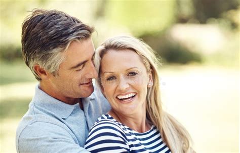 Making Time For A Little Romance An Affectionate Mature Couple Enjoying A Day In The Park