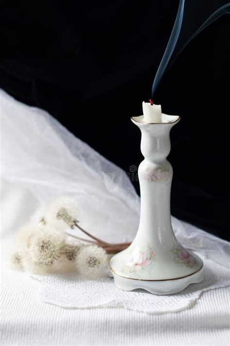 Still Life With An Antique Porcelain Candlestick And Smoke From An