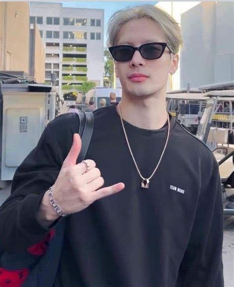 A Man With Sunglasses And A Black Shirt Giving The Peace Sign While