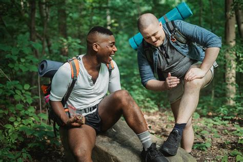 Cheerful multiethnic hikers resting in forestFree Stock Photo