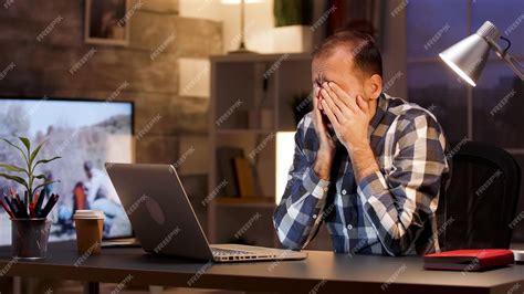 Free Photo Tired Businessman Yawn And Rubbing Eyes In Home Office During Late Night Hours