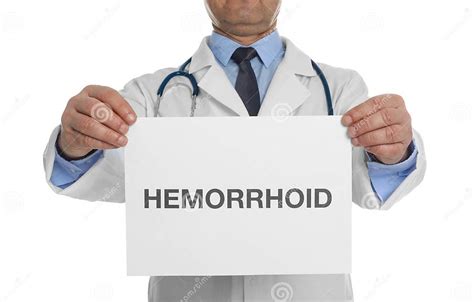 Doctor Holding Sign With Word Hemorrhoid On Background Closeup Stock