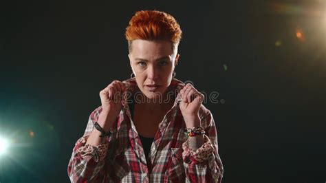 Confident Lesbian In Stylish Attire Poses Against Illuminated Dark Backdrop Stock Video Video