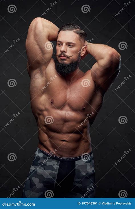 Self Confident Bodybuilder Posing In Dark Background Stock Image