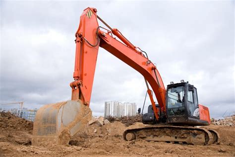 Premium Photo Red Excavator During Earthworks At Construction Site