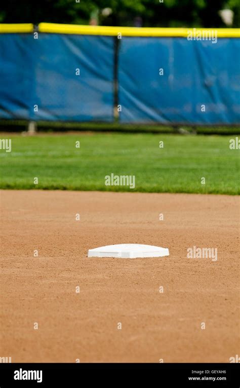 White second base on baseball field Stock Photo - Alamy