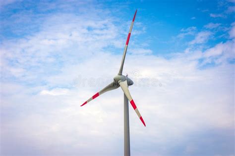 Single Windmill Generating Electricity Against Blue Sky Beautiful Wind