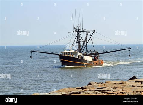 A Commercial Fishing Trawler Returning From Work And About To Enter The