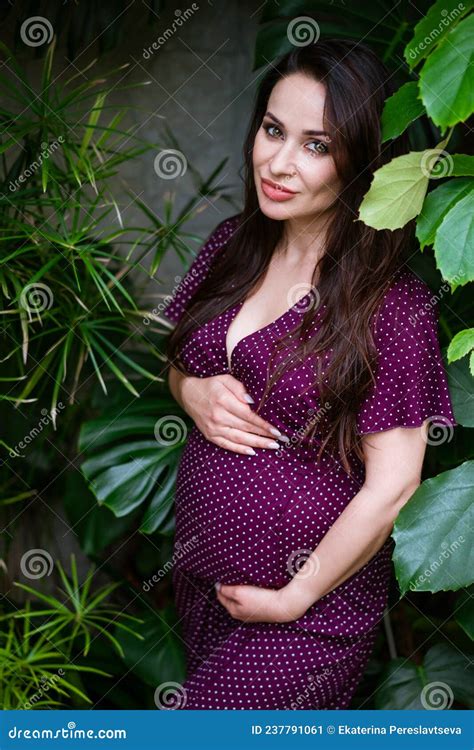 Beautiful Pregnant Woman Feels Great In Beautiful Dress With Long Flowing Hair Stock Image