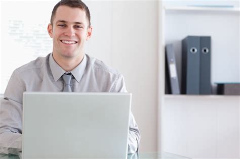 Premium Photo | Happy businessman working on his laptop