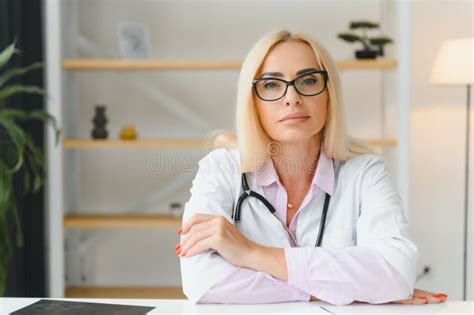 Portrait Of Middle Age Female Doctor Is Wearing A White Doctor S Coat