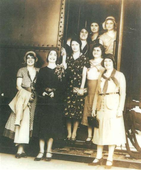 An Old Black And White Photo Of Women Standing In Front Of A Train