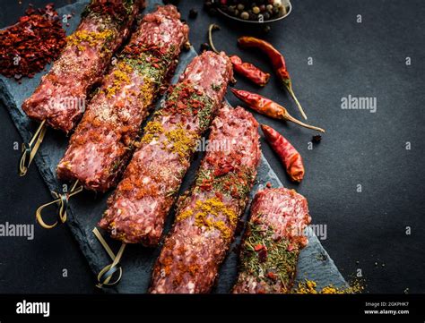 Raw kebab with spices Stock Photo - Alamy