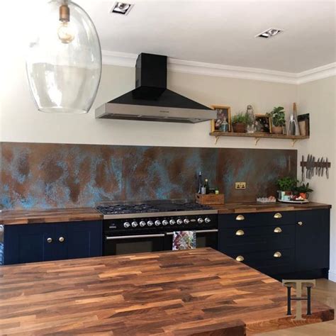 A Kitchen With Blue Cabinets And An Oven