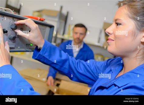 worker adjusting dial  machine stock photo alamy