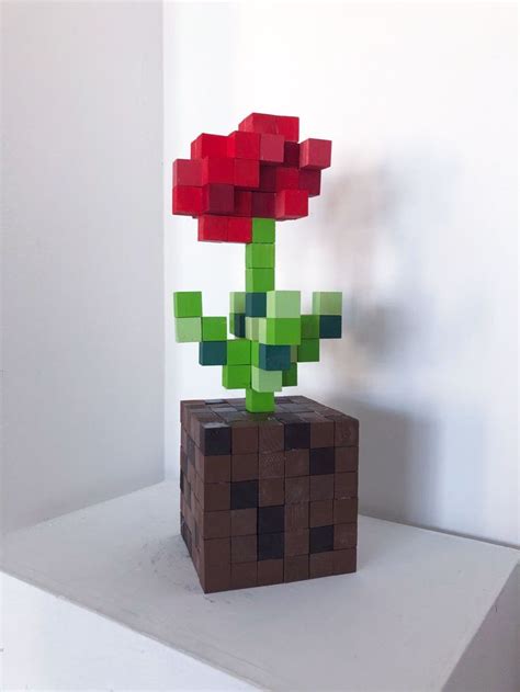 A Flower Made Out Of Lego Blocks Sitting On Top Of A White Table Next