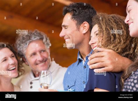 Family laughing together indoors Stock Photo - Alamy