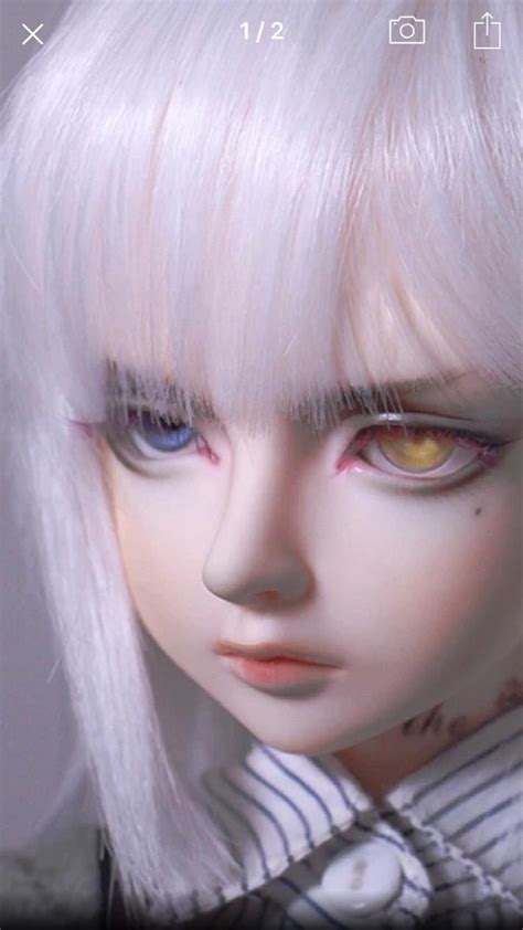 A Doll With White Hair And Blue Eyes