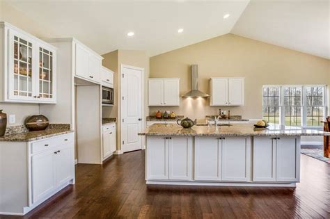 Modern Kitchen Design with White Cabinets and Wood Flooring