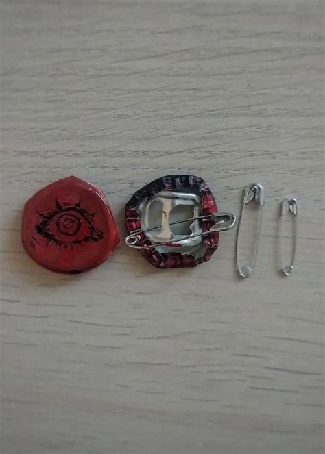 Two Red And Black Objects Sitting On Top Of A Wooden Table Next To Each