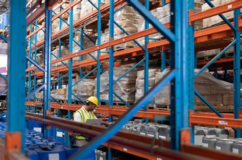 Premium Photo Male Worker Checking Stocks In Warehouse