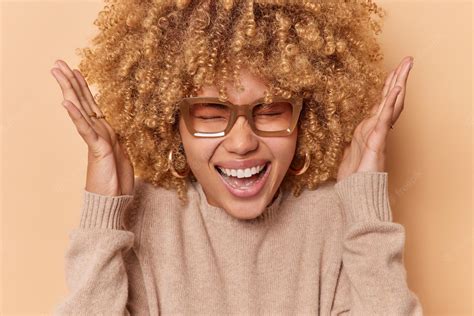 Premium Photo Headshot Of Overjoyed Happy Curly Woman Raises Hands