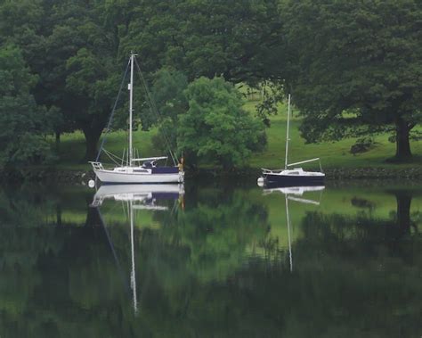 Premium Photo Boats Sailing On Lake By Trees