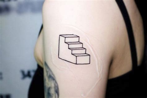 Minimalistic stairs tattoo located on the upper arm.