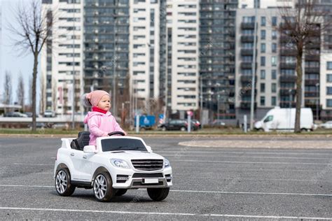 Premium Photo Little Girl Drives A Big White Childrens Electric Toy