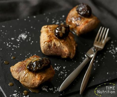 Three Pastries On A Black Plate With A Fork And Knife Next To Them