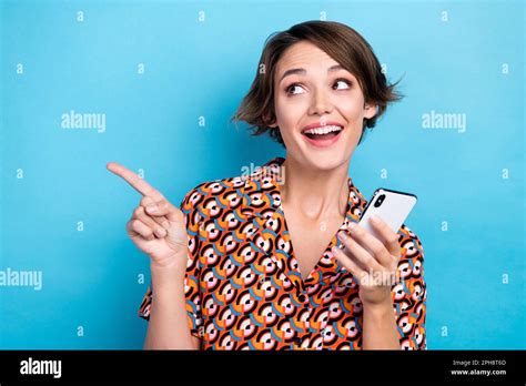 Photo Of Funny Positive Lady Hold Telephone Look Indicate Finger Empty