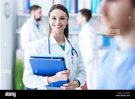 Confident Attractive Female Doctor In The Office Holding Medical