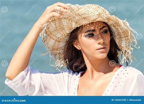 Portrait Of Beautiful Young Woman Wearing Summer Hat At Beach Closeup