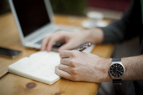 Man Wearing Silver Analog Watch Holding A Pen Writing On A Book Hd Wallpaper Wallpaper Flare