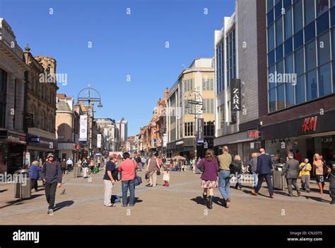 Busy Main High Street Scene With People Shopping In The City Centre