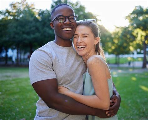 Love Interracial Or Couple Of Friends Hug In A Park On A Happy Romantic Date Bonding In Nature