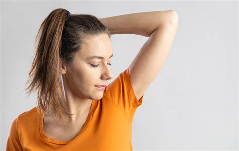 Young Woman Smelling Her Armpits Stock Photo Download Image Now