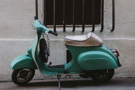 Premium Photo Scooter Parked On Footpath Against Wall