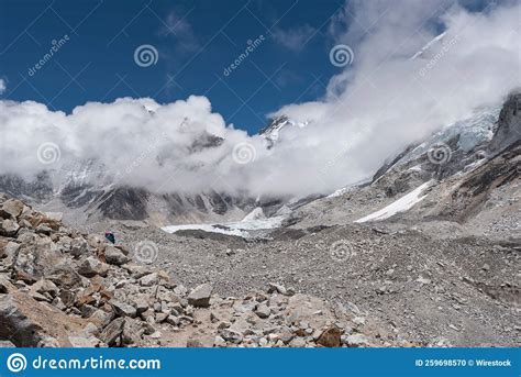 Peaks Of Mount Everest Covered With Thick Clouds Under A Blue Clear Sky