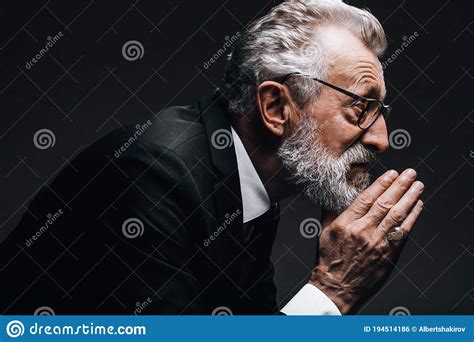 Old Aged Thoughtful Businessman In Classic Suit Is Looking Away Posing