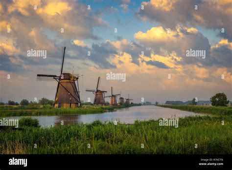 Sunset Above Historic Windmills In Kinderdijk Netherlands Stock Photo