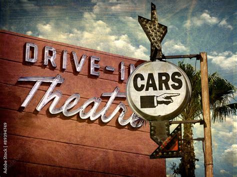 aged and worn vintage photo of neon drive in sign Stock Photo | Adobe Stock