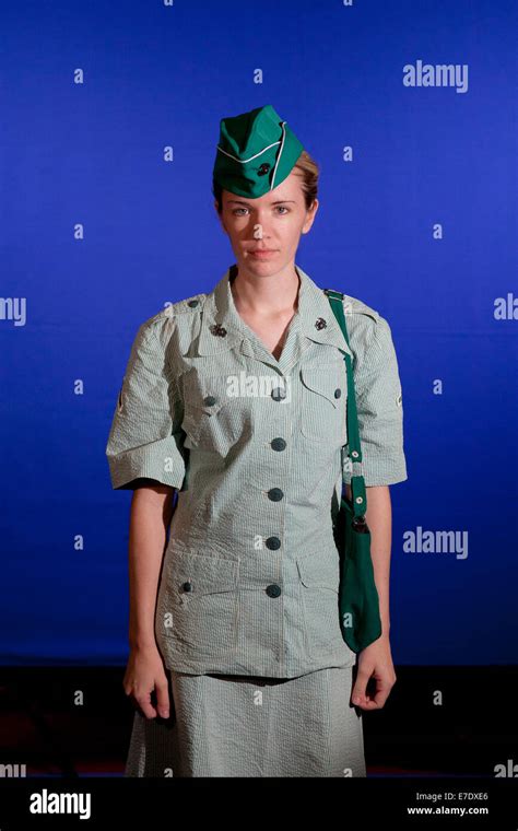 A female US Marine dressed in a period Summer Service Uniform uniform participates in the ...