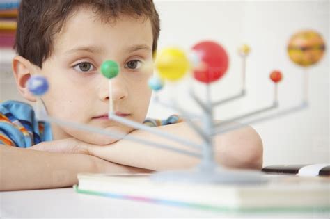 Boy Inspecting Solar System Model stock photo (287340) - YouWorkForThem